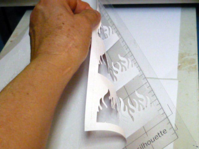 Peeling cut cardstock off the adhesive mat