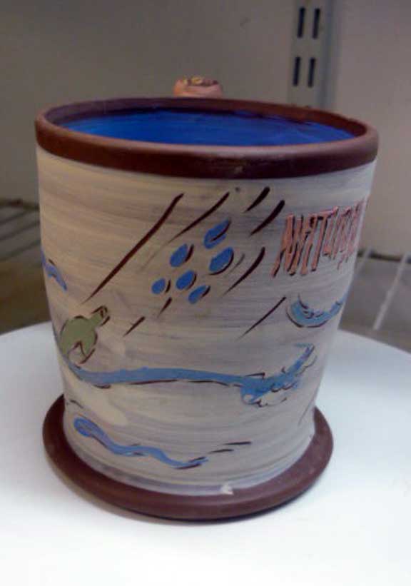Arbuckle terracotta cup w slip on leatherhard clay w Tyvek stencil images. Greenware. Natural Disaster: Flood.