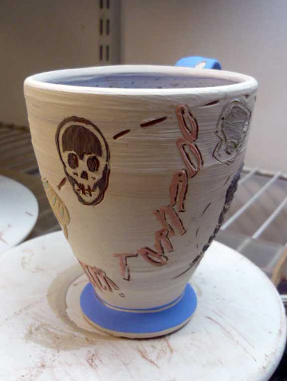 Arbuckle terracotta cup with slip on leatherhard clay w Tyvek stencils and sgraffito. Natural Distaster: Tornado. Greenware.